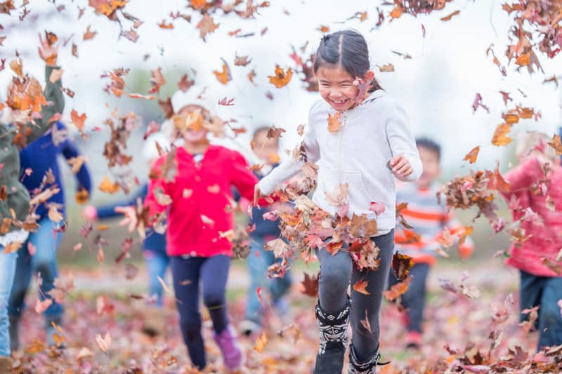 Kids walking in leaves